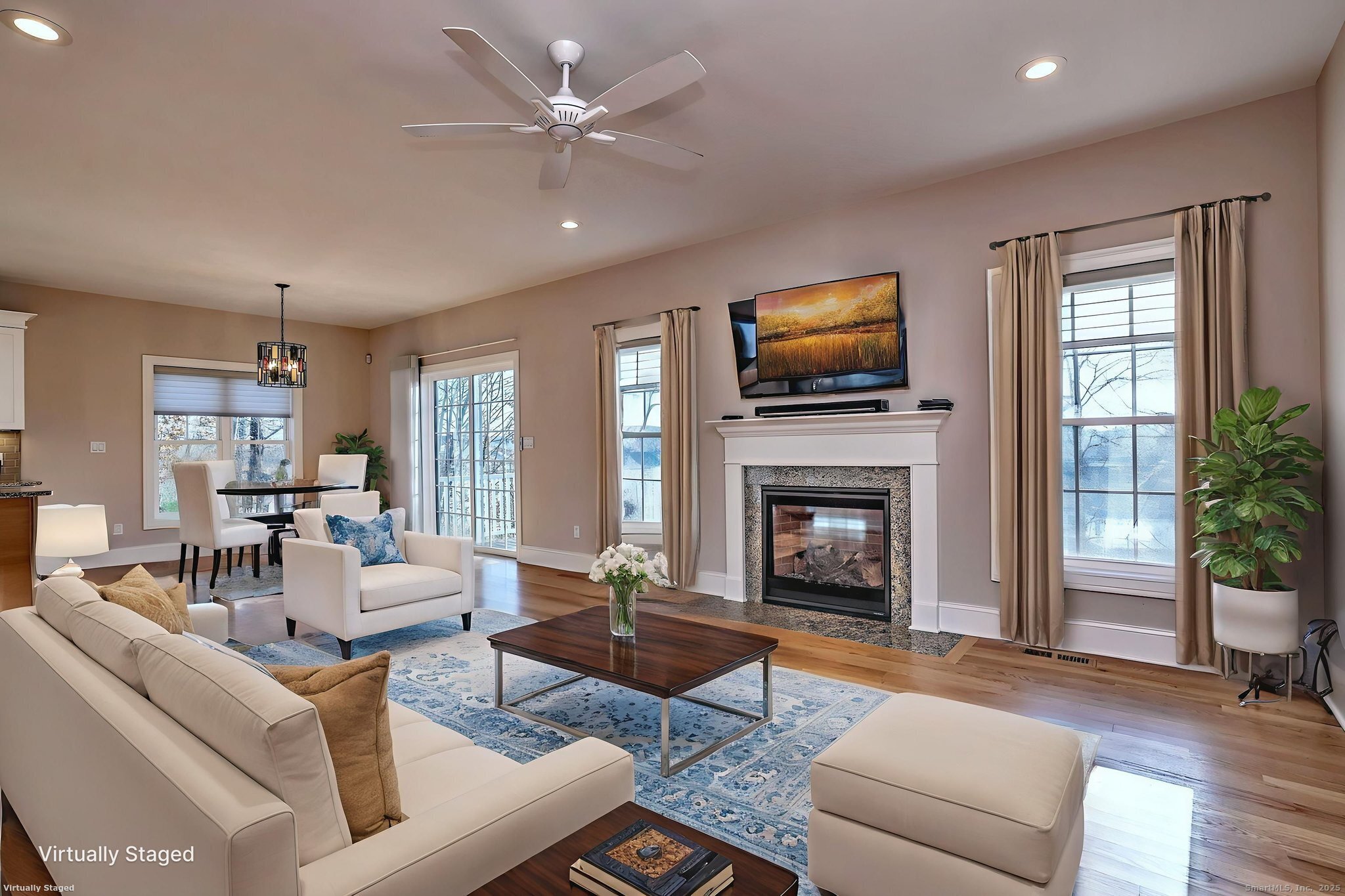 126 Wells View Road, Unit 126 Shelton, CT 06484 - Photo 10 of 26 a living room with furniture a fireplace and a flat screen tv