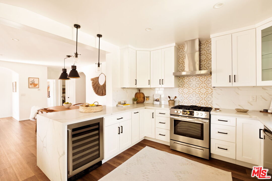 1275 North Craig Avenue Pasadena, CA 91104 - Photo 12 of 30 a kitchen with stainless steel appliances granite countertop a stove a sink and white cabinets