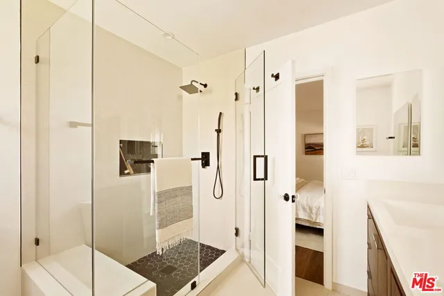 a bathroom with a shower and a sink