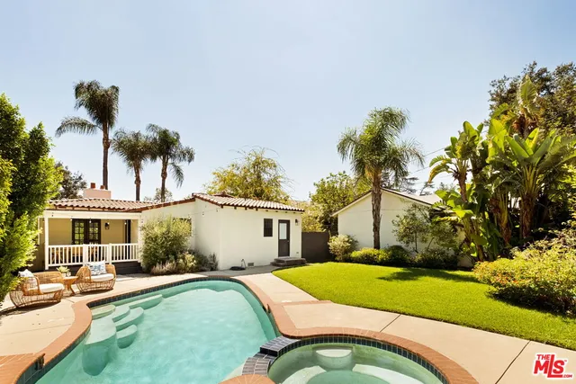 a swimming pool with outdoor seating and yard