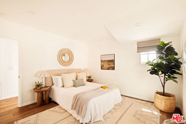 a bedroom with a bed and a potted plant