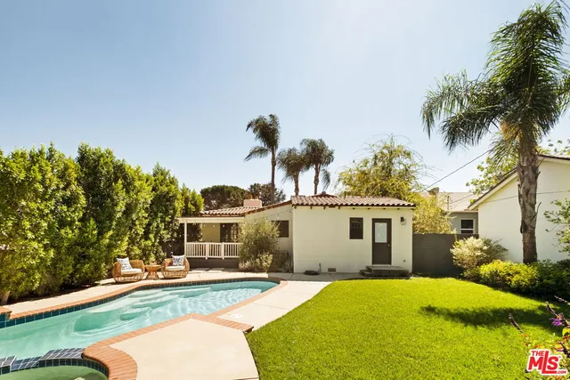 a house with palm tree in front of it