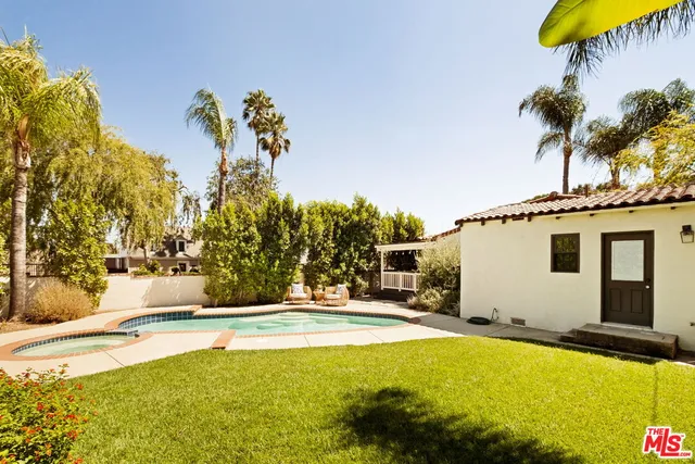 a swimming pool with yard and outdoor seating
