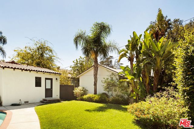 a view of backyard of house with green space