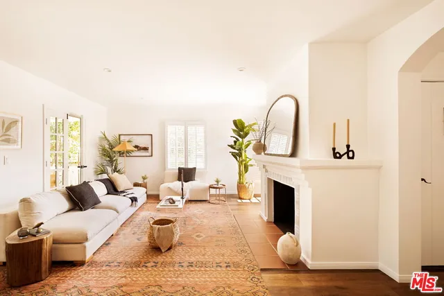 a living room with furniture a fireplace and a rug
