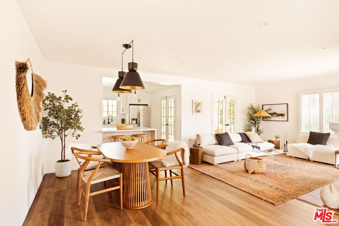 1275 North Craig Avenue Pasadena, CA 91104 - Photo 9 of 30 a living room with furniture a chandelier and a dining table
