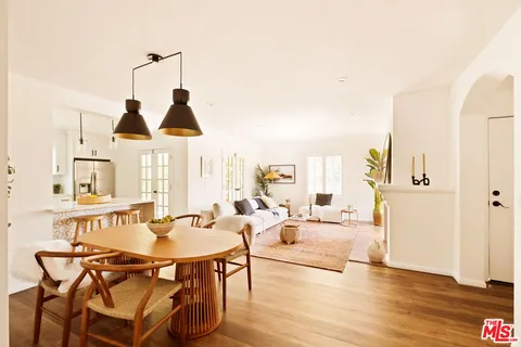 a living room with furniture a rug and white walls