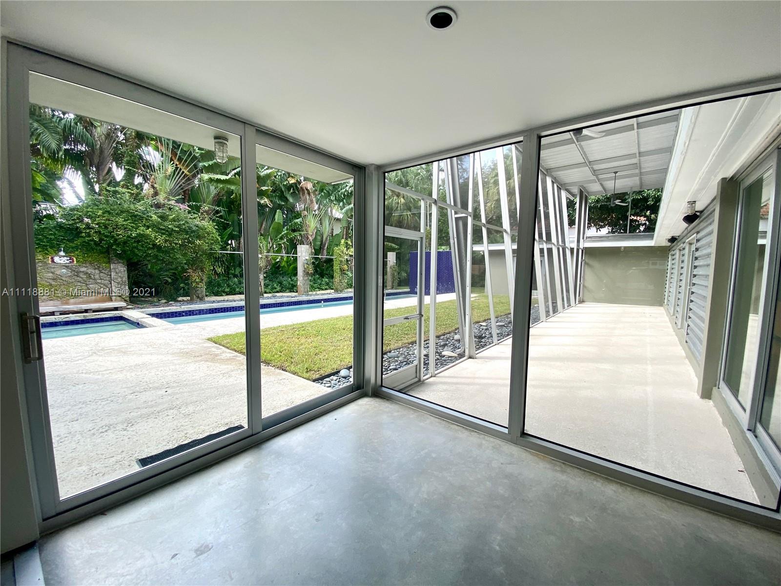 3620 Solana Road Miami, FL 33133 - Photo 2 of 23 a view of an empty room with wooden floor and a floor to ceiling window