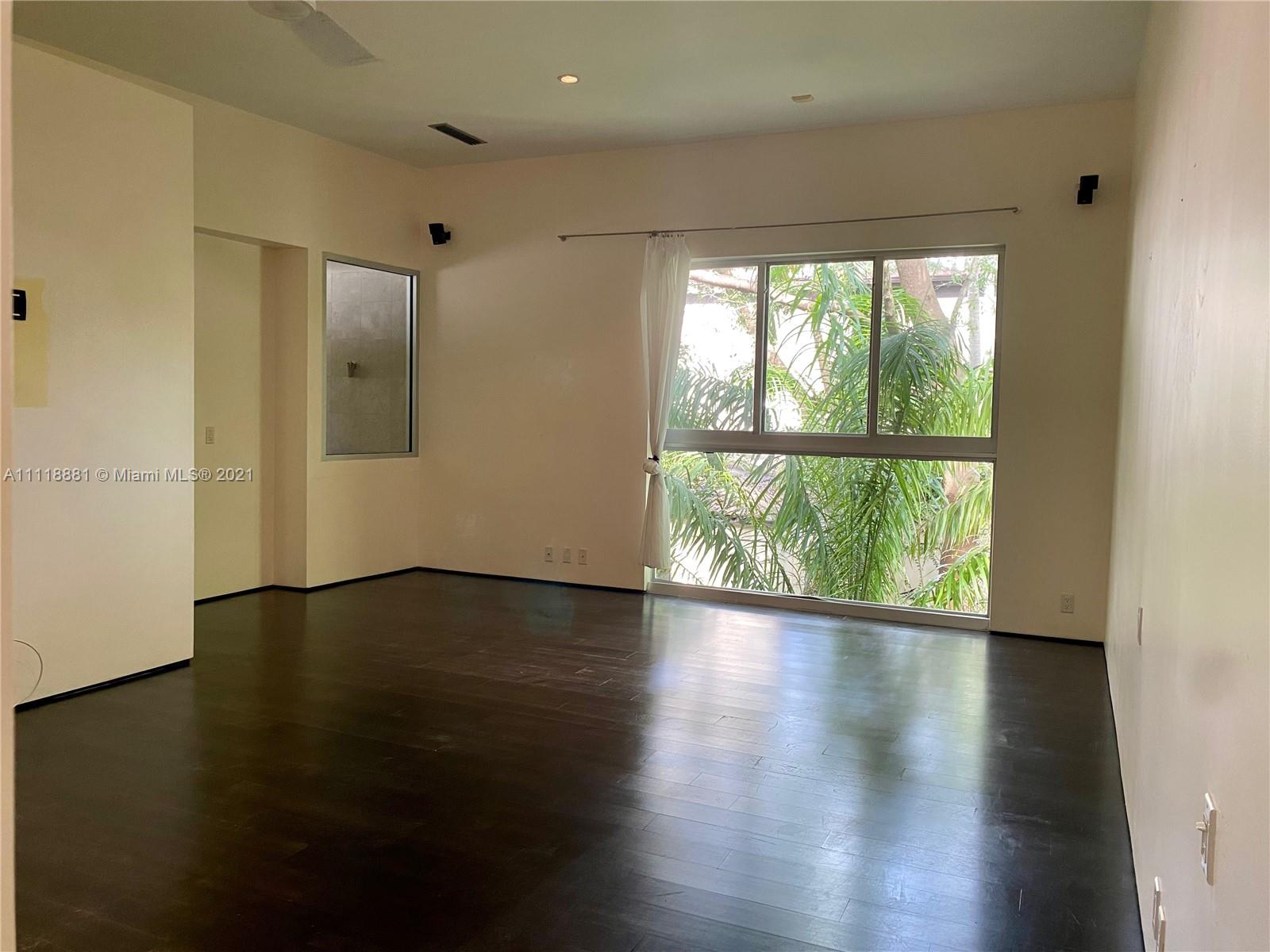 3620 Solana Road Miami, FL 33133 - Photo 15 of 23 a view of an empty room with wooden floor and a window