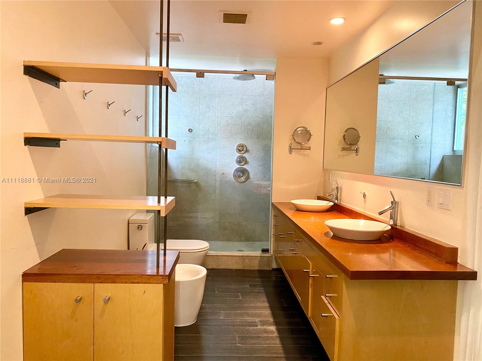 3620 Solana Road Miami, FL 33133 - Photo 16 of 23 a bathroom with a double vanity sink a toilet and shower