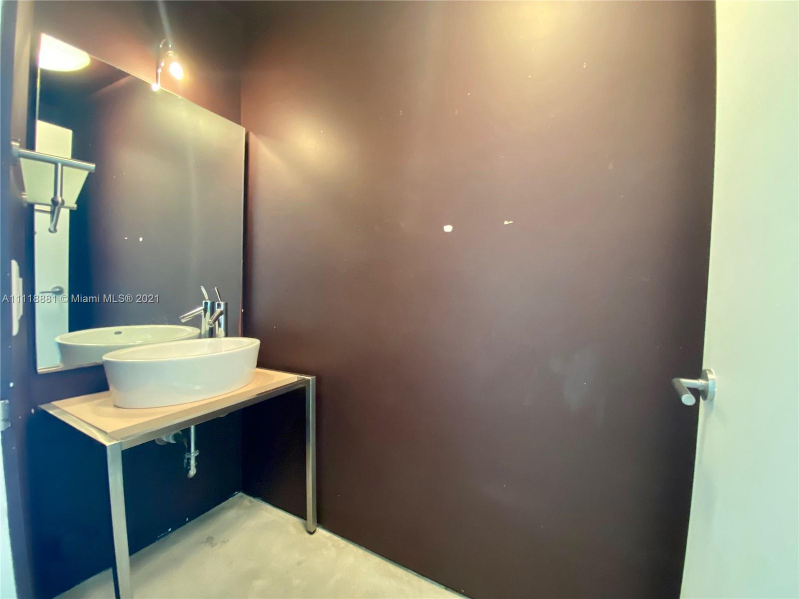 3620 Solana Road Miami, FL 33133 - Photo 3 of 23 a bathroom with a sink and a mirror