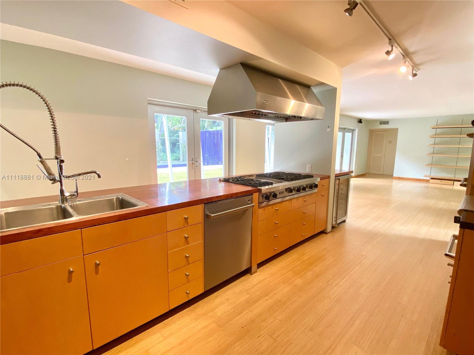 3620 Solana Road Miami, FL 33133 - Photo 5 of 23 a kitchen with stainless steel appliances granite countertop a sink a stove and a wooden floors