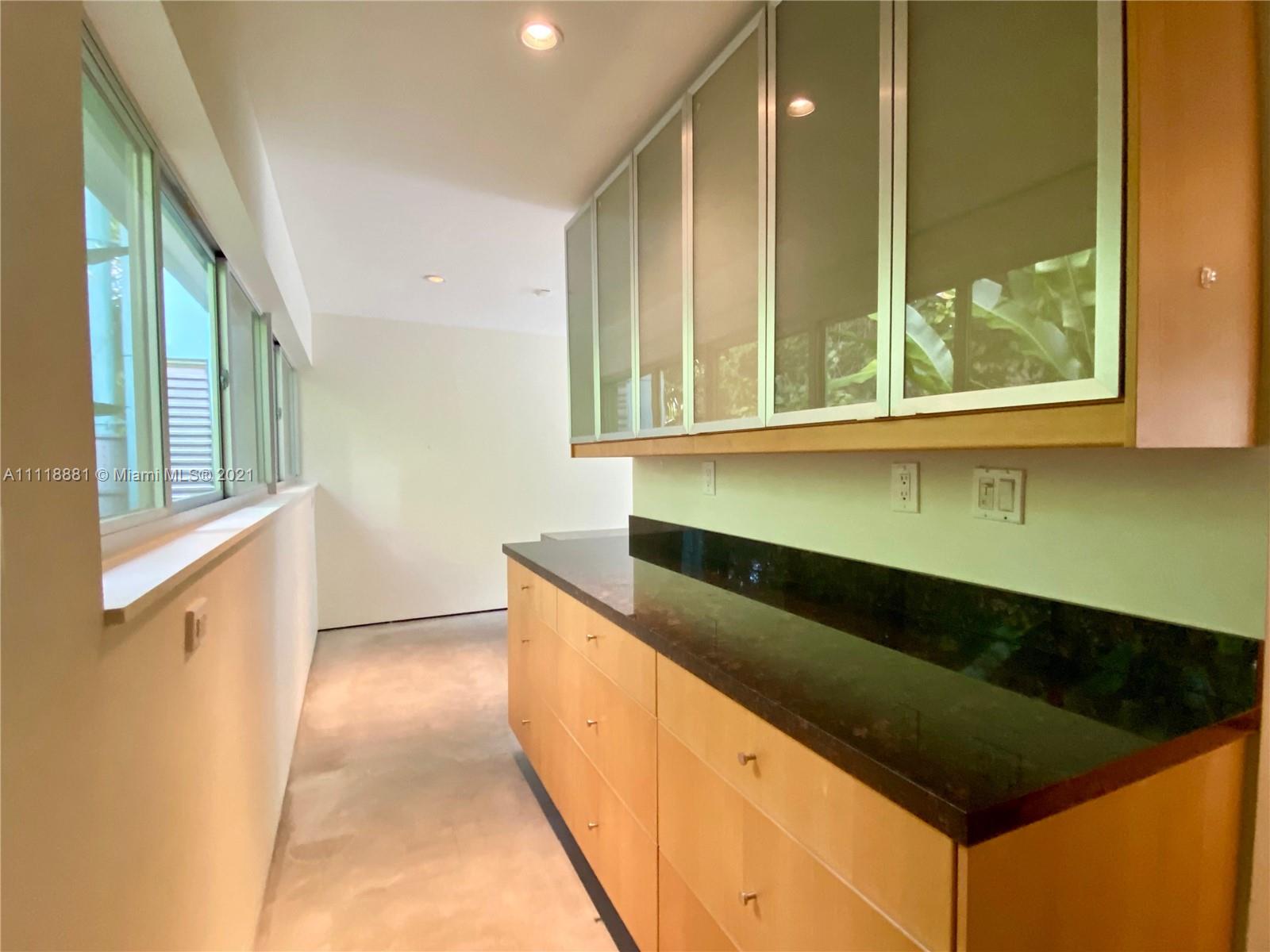 3620 Solana Road Miami, FL 33133 - Photo 6 of 23 a kitchen with a refrigerator and a sink
