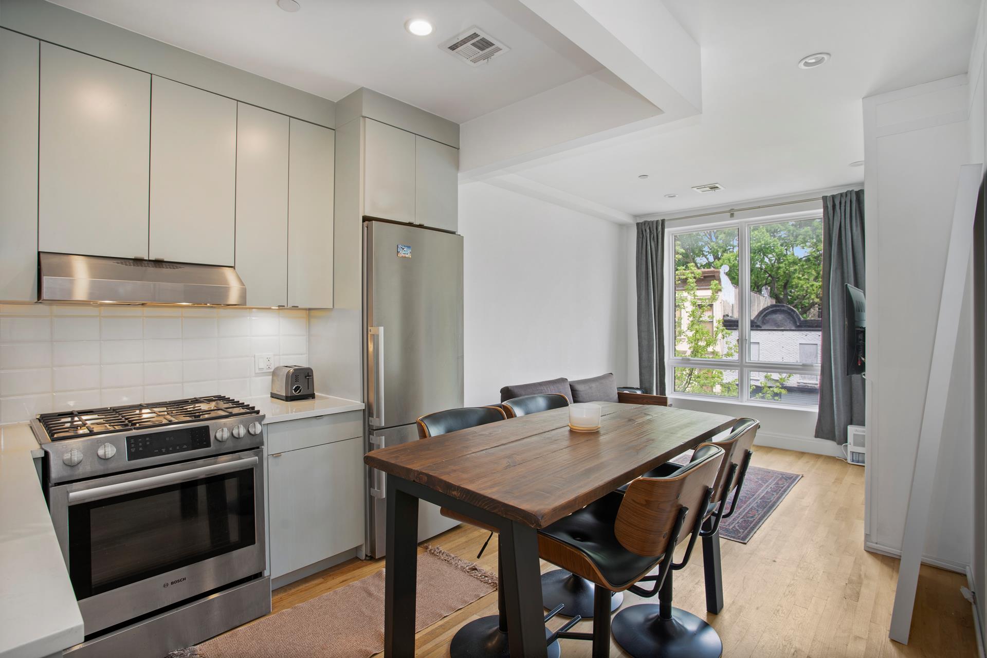 686 MacDonough Street, Unit 3A Brooklyn, NY 11233 - Photo 1 of 7 a kitchen with a stove a sink and a refrigerator
