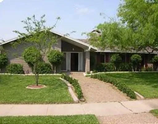 a garden with trees in front of it