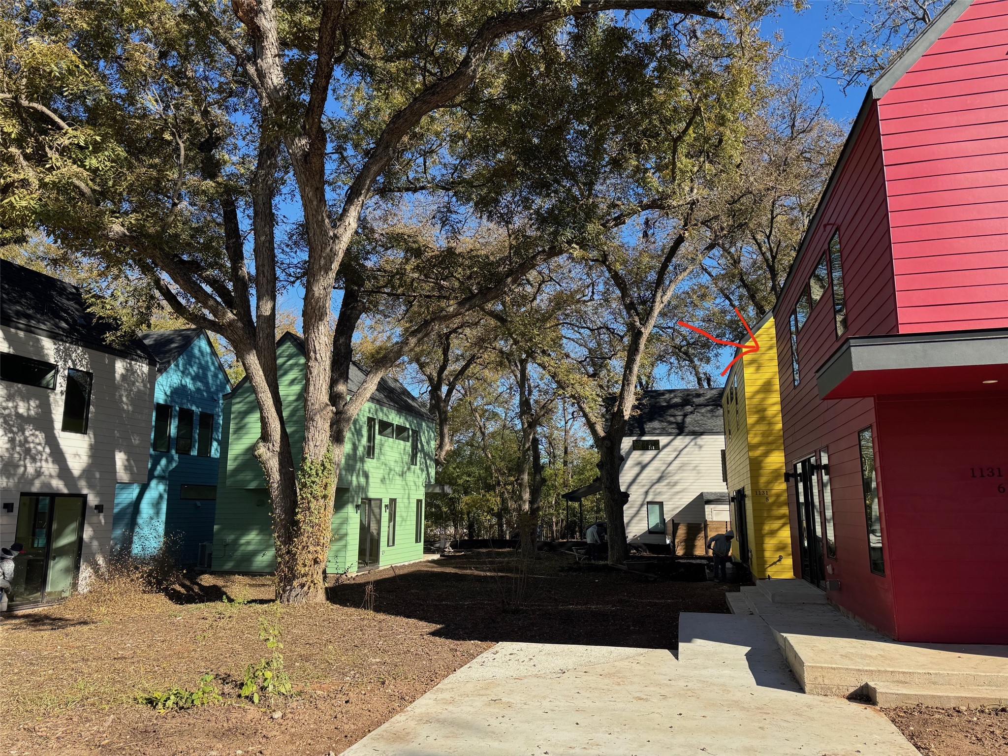 1131 Walton Lane, Unit 6 Austin, TX 78721 - Photo 12 of 16 a view of a street with a tree in the background
