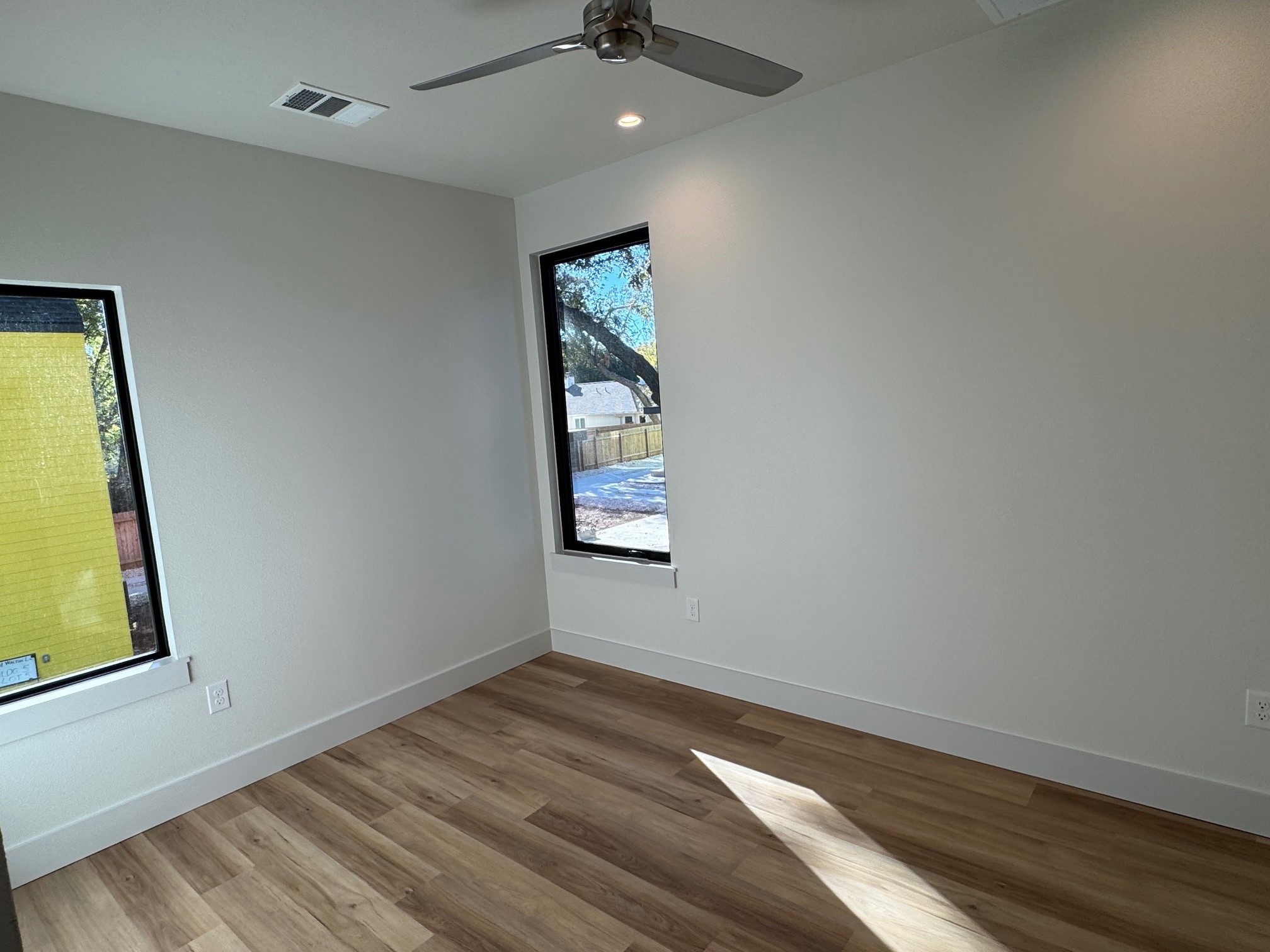 1131 Walton Lane, Unit 6 Austin, TX 78721 - Photo 6 of 16 wooden floor in an empty room with a window