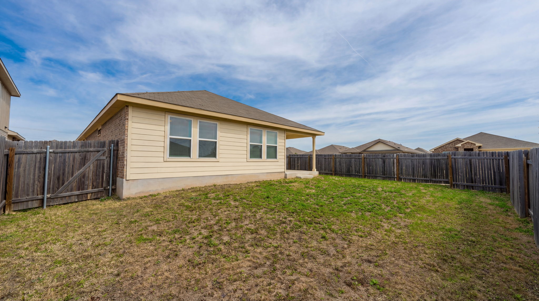 1003 Round Bale Road Hutto, TX 78634 - Photo 14 of 29 Back of property with a fenced backyard and a gate