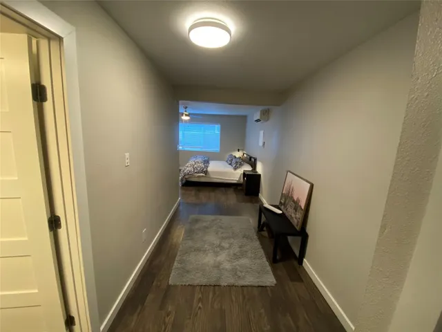 a view of hallway with wooden floor