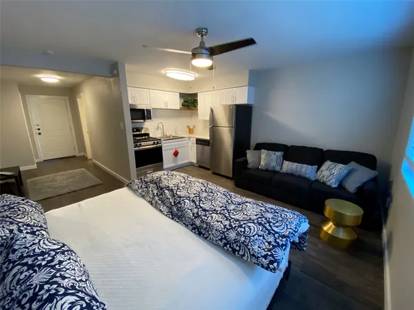 a living room with a couch and a refrigerator