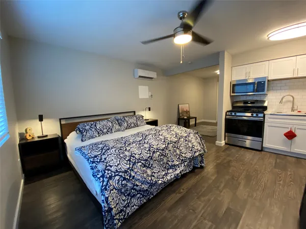 a bed room with a bed and a television