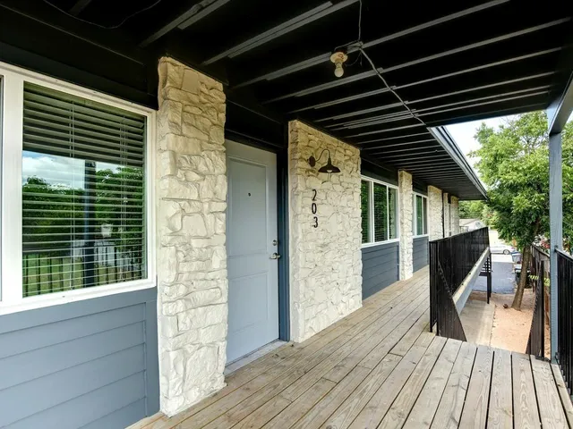 a front view of a house with potted plants