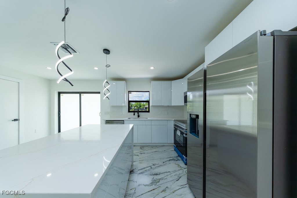 2019 Hamilton Avenue Alva, FL 33920 - Photo 12 of 50 a view of a kitchen with a sink and a refrigerator