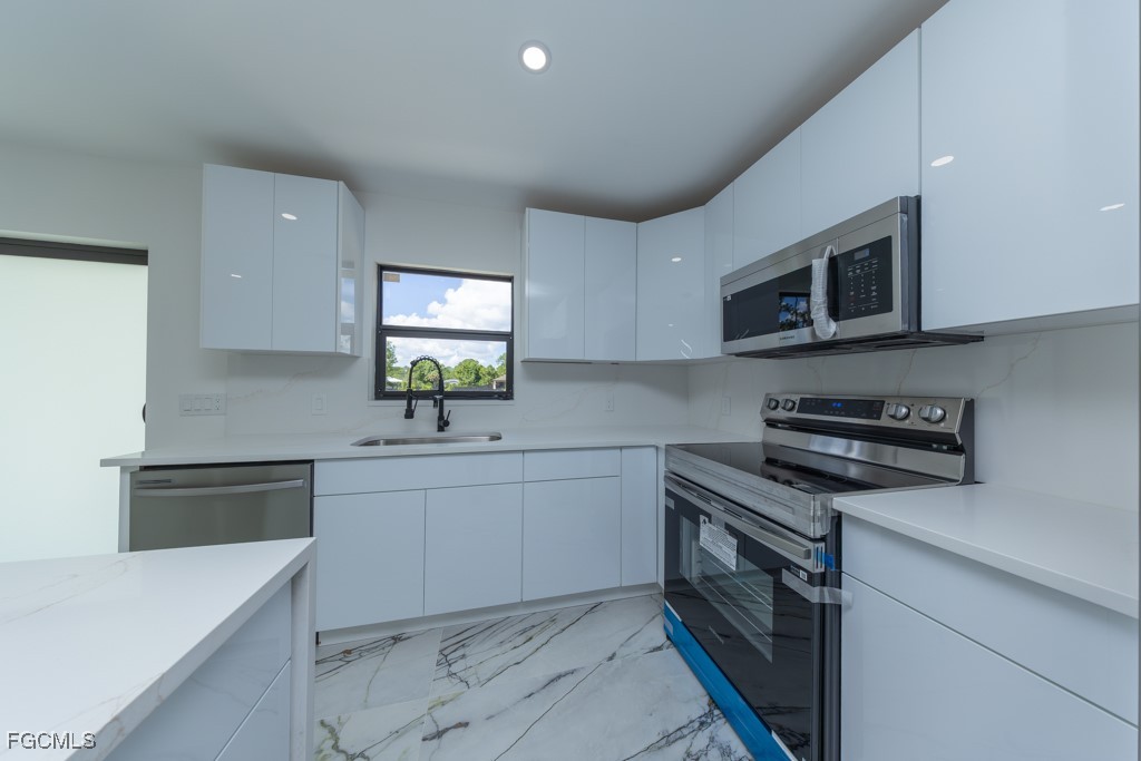 2019 Hamilton Avenue Alva, FL 33920 - Photo 14 of 50 a kitchen with a sink stove and microwave