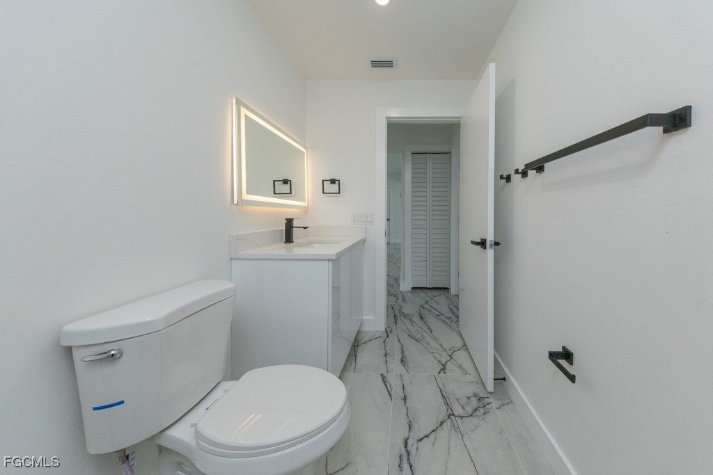 2019 Hamilton Avenue Alva, FL 33920 - Photo 20 of 50 a white toilet sitting next to a bathroom sink