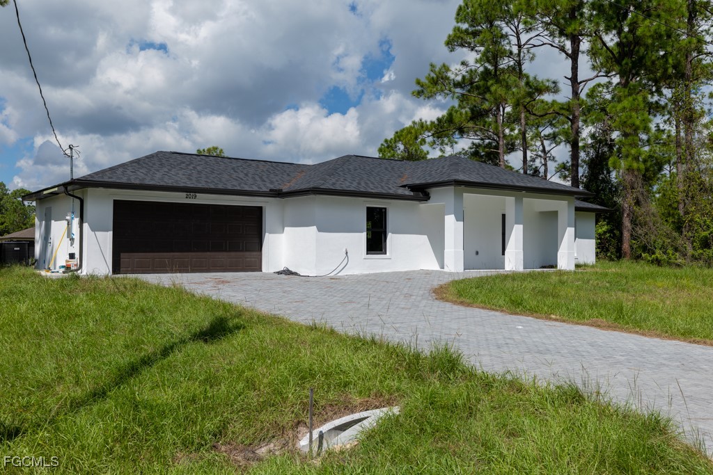2019 Hamilton Avenue Alva, FL 33920 - Photo 2 of 50 a front view of a house with a yard and garage