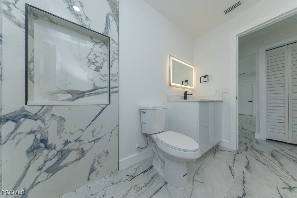 2019 Hamilton Avenue Alva, FL 33920 - Photo 21 of 50 a white toilet sitting next to a bathroom sink