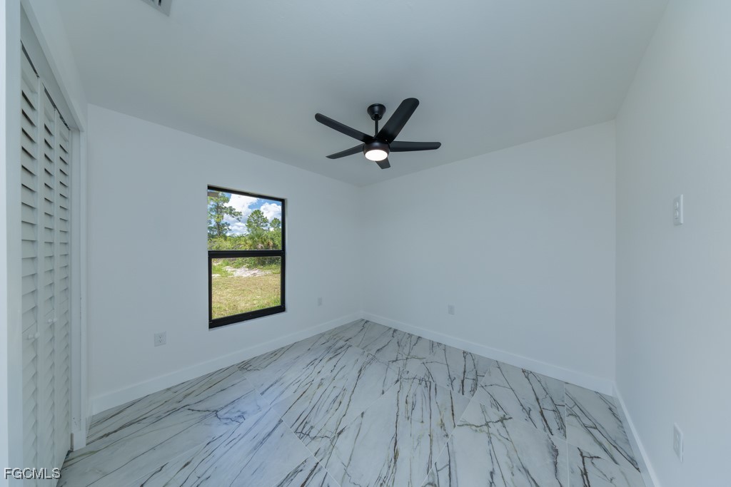 2019 Hamilton Avenue Alva, FL 33920 - Photo 24 of 50 an empty room with wooden floor and a ceiling fan