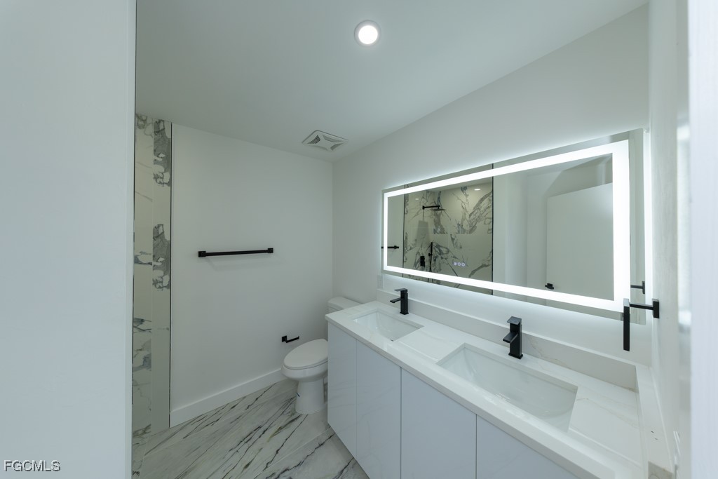 2019 Hamilton Avenue Alva, FL 33920 - Photo 40 of 50 a bathroom with a sink and a large mirror