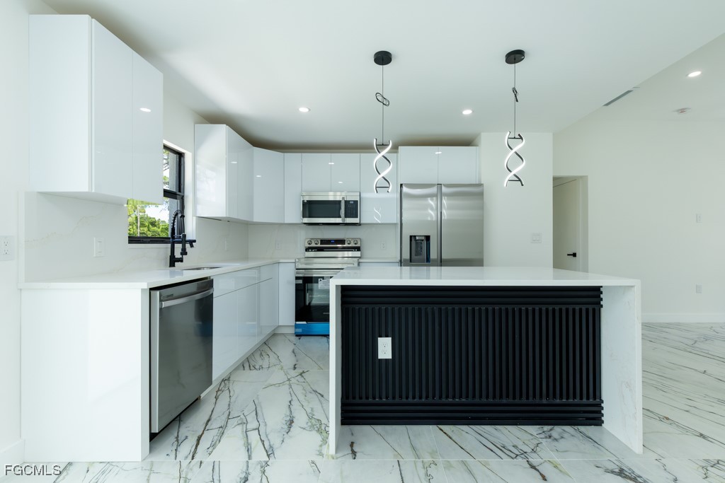 2019 Hamilton Avenue Alva, FL 33920 - Photo 6 of 50 a kitchen with stainless steel appliances granite countertop a refrigerator and a sink