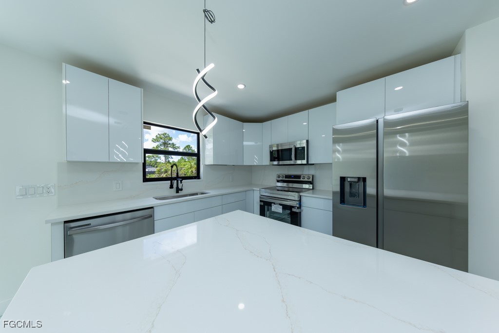 2019 Hamilton Avenue Alva, FL 33920 - Photo 9 of 50 a kitchen with stainless steel appliances a refrigerator and a stove top oven