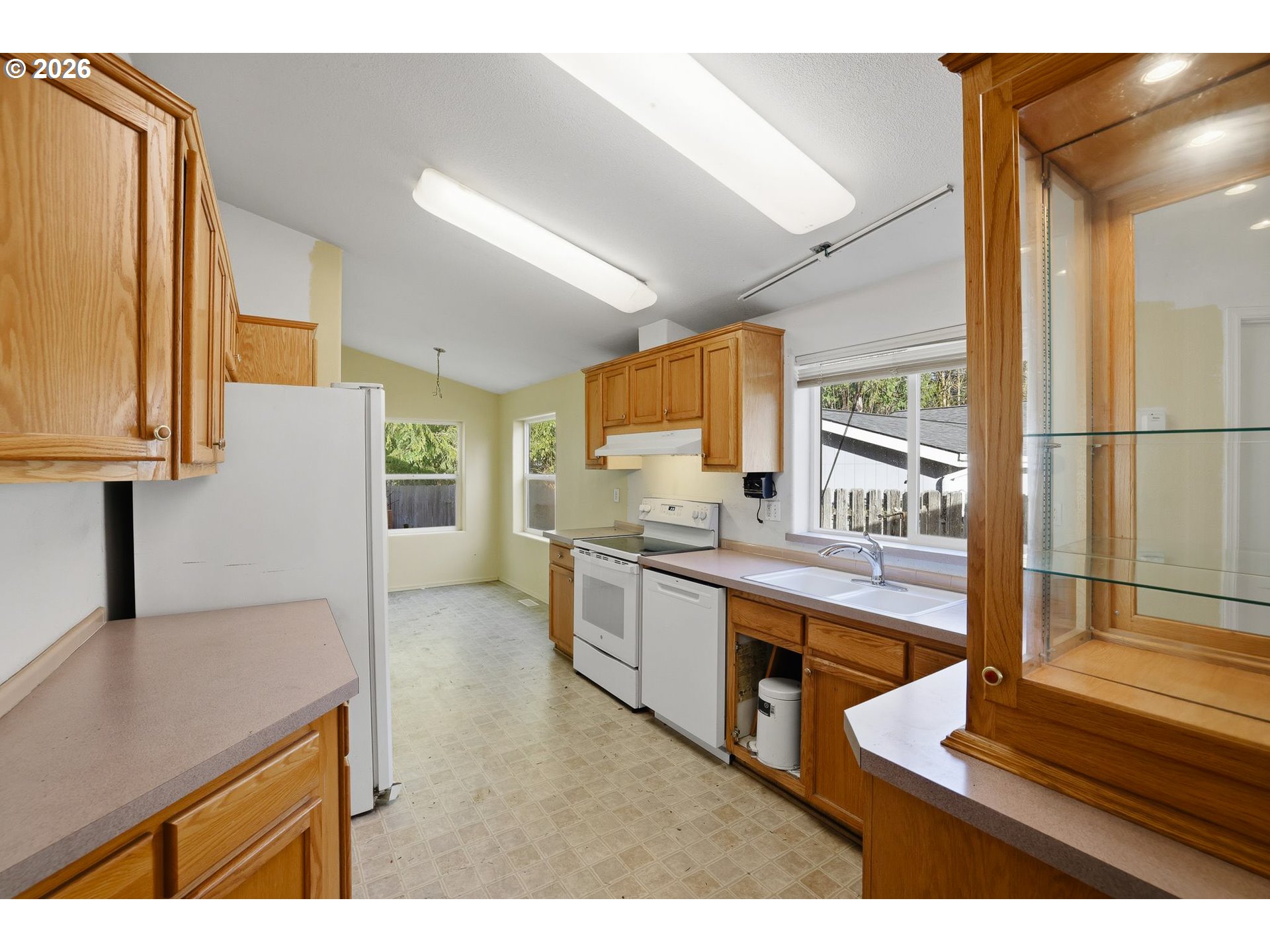 25368 East Cedar Glen Loop Welches, OR 97067 - Photo 11 of 25 a kitchen with stainless steel appliances kitchen island granite countertop a sink and cabinets