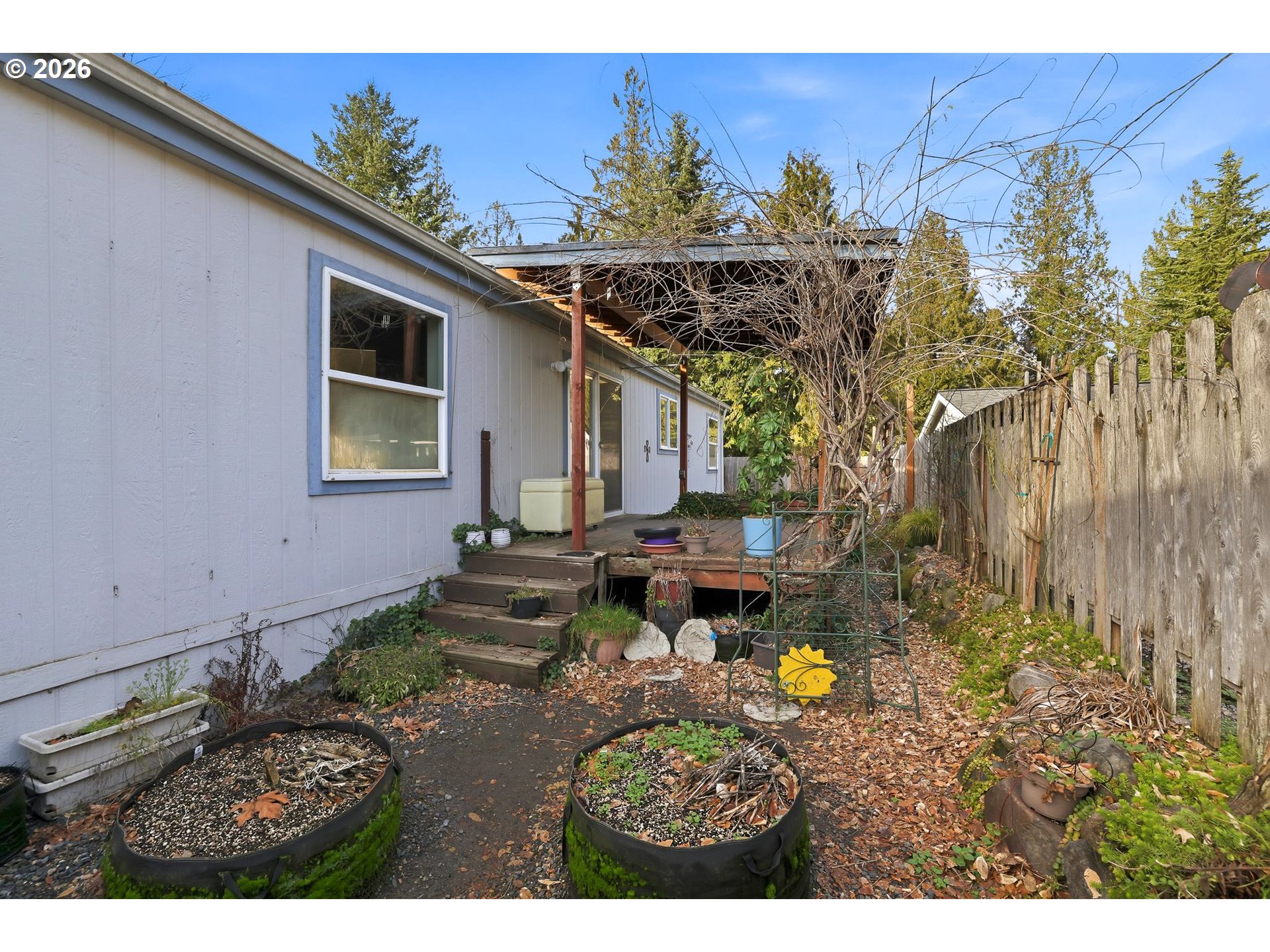 25368 East Cedar Glen Loop Welches, OR 97067 - Photo 24 of 25 a view of a backyard with table and chairs and potted plants