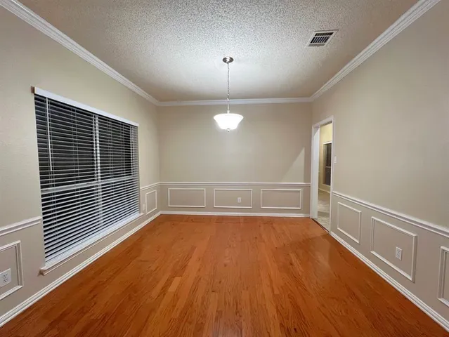 a view of a room with wooden floor and white walls