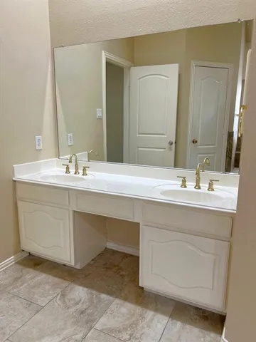 a bathroom with a sink vanity and a mirror