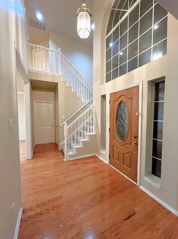 a view of an entryway with wooden floor