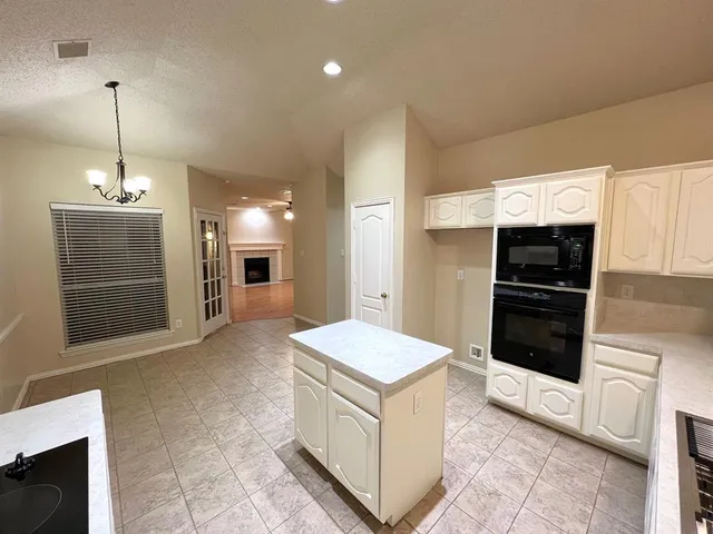 a view of kitchen with windows and refrigerator