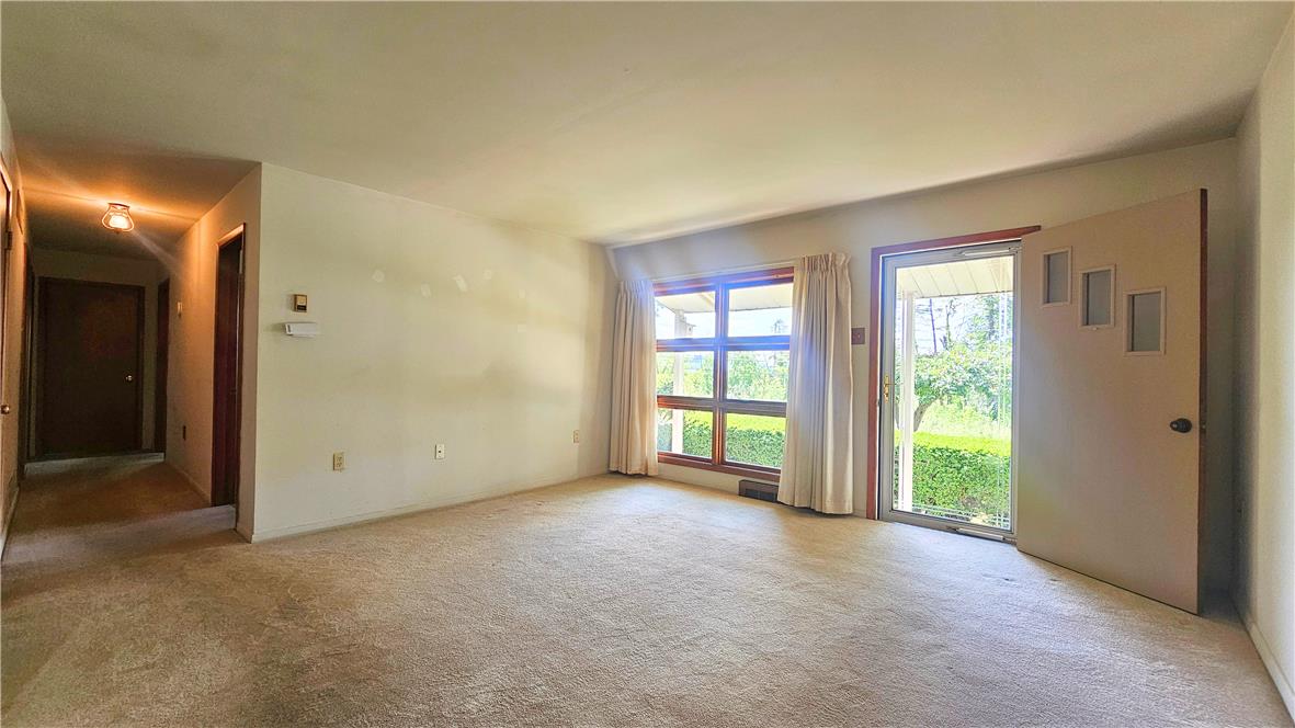 2529 Ringhoffer Road Hellertown, PA 18055 - Photo 8 of 33 Sun-filled living space featuring a large window and convenient exterior access.