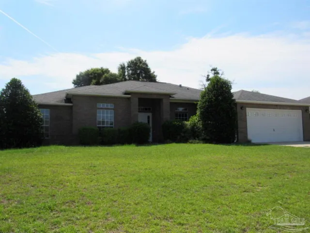 a front view of a house with yard and garage