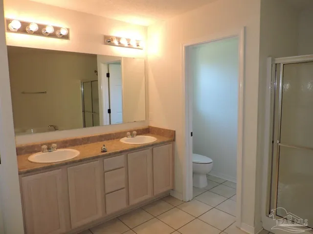 a spacious bathroom with a granite countertop sink and a mirror