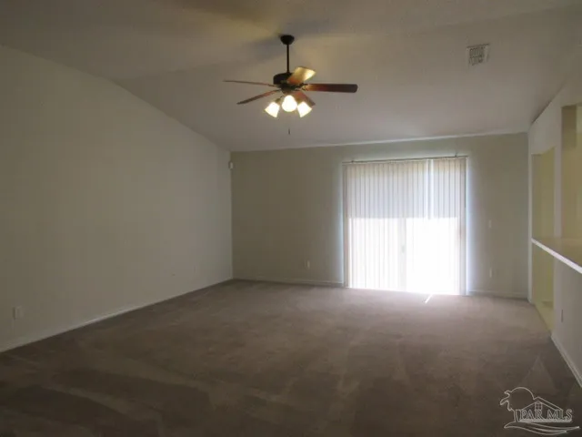 a view of an empty room with a window