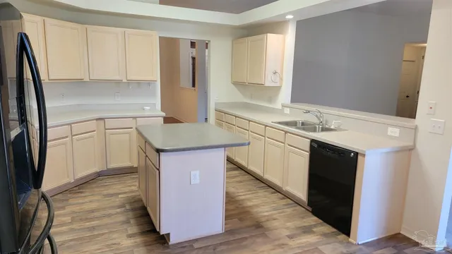 a kitchen with stainless steel appliances granite countertop a refrigerator a stove a microwave a sink and cabinets