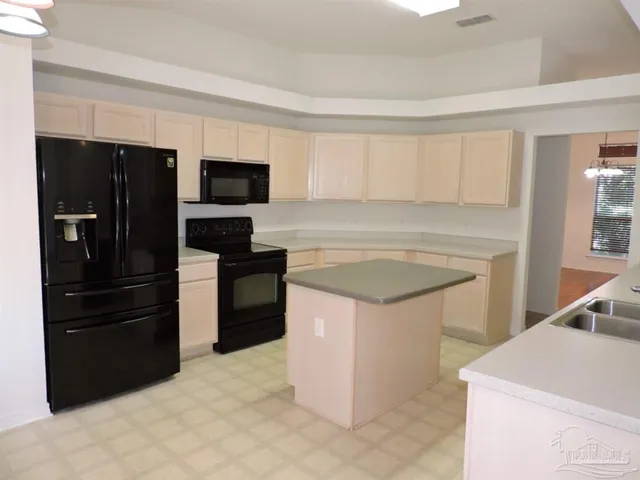 a kitchen with a sink and a refrigerator