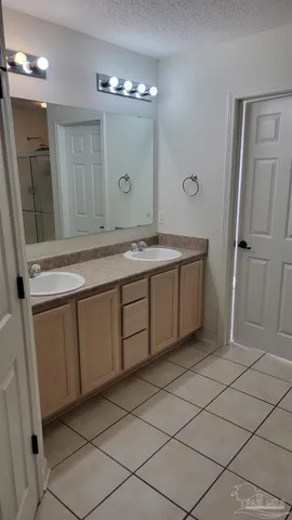 a bathroom with a double vanity sink and mirror