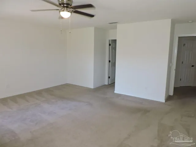 a view of a room with a ceiling fan