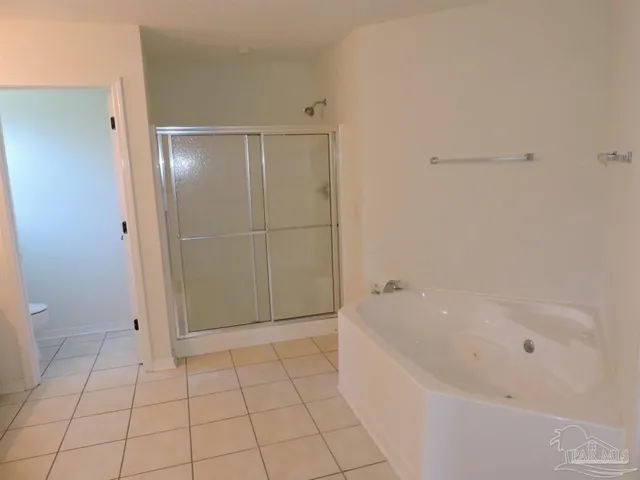 a bathroom with a bathtub and shower